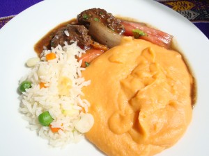 Delicious dish in the background, accompanied by a juicy tenderloin.