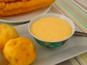 Huancaína sauce, accompanied by yellow potatoes and corn.